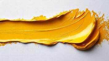 Bright yellow paint applied to a canvas. Vibrant yellow acrylic paint is smoothly spread across a white surface, creating an artistic texture and depth. photo