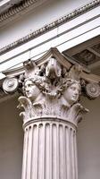 A close up of a column with two heads on it photo