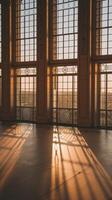 Sunlight shining through large windows in an empty building photo