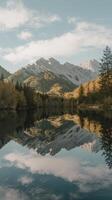 A lake with mountains reflected in it photo