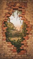 A brick wall with a hole in it and a tree growing out of it photo