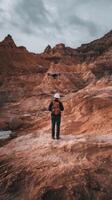 A man standing in the desert with a drone photo