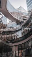 A building with a curved glass facade and a lot of windows photo