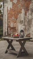 A table with a bowl of apples and a lantern on it photo