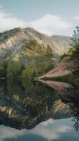 A mountain lake with trees and a mountain in the background photo