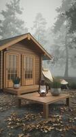 A small wooden cabin in the woods with a table and chairs photo