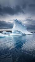Icebergs floating in the ocean under a cloudy sky photo