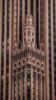 The top of a tall building with a clock on it photo