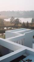 A white building with a lake in the background photo