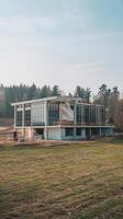A large building under construction in a field photo