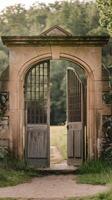 An open gate to a stone building in a field photo
