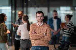 A successful business team working together in a modern startup office. Executives and employees collaborate, brainstorm, and showcase teamwork, leadership, and innovation in a confident, dynamic photo