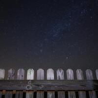 A wooden fence with stars in the sky photo