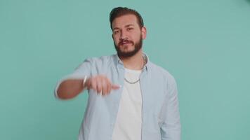 Upset handsome man guy in shirt showing thumbs down sign gesture, disapproval dissatisfied dislike video
