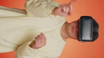 Handsome man using virtual reality headset helmet to play simulation game app watching content video