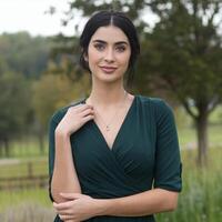 A woman in a green dress posing for a photo