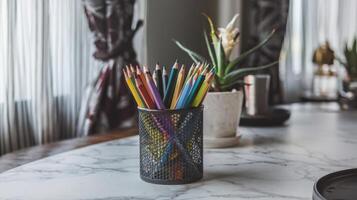 A vase of flowers and a vase of colored pencils on a table photo