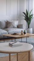 A white table with a book on it in front of a couch photo