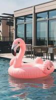 An inflatable flamingo floating in a pool photo