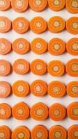 Creative layout of sliced carrot vegetable pattern food background isolated on white flat lay top view photo