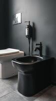A black toilet and sink in a bathroom photo