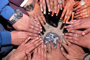 A group of people holding hands in a circle photo