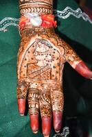 A woman's hand with henna on it photo