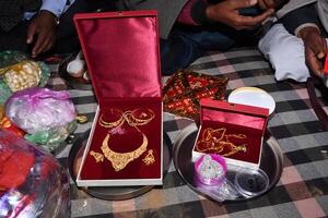 A table with a red box and some jewelry photo