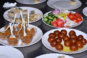 A table with many plates of food photo