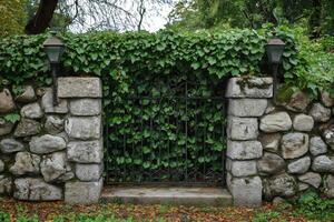 Ivy covered gate and stone wall with lanterns in a park photo