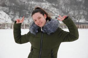 Winter joy in nature with smiling woman in green coat photo