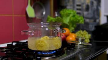 pasta nests Cooking process Step by step Water boils in a saucepan as nests of thin pasta are added to cook delicate spaghetti. Thin spaghetti noodles in the shape of a nest. instant noodles video