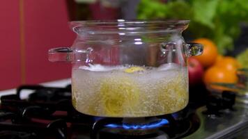 Spaghetti in a transparent pan with boiling water. Spaghetti in boiling water. Spaghetti boils in pan. Spaghetti in a transparent pan close-up video