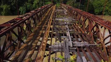 an old rusty bridge in the middle of a river video
