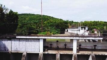 a dam with a large concrete structure and a few people standing on the side video