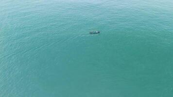 Aerial View of a Small Boat Gliding Through the Calm Turquoise Waters of the Ocean video