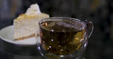 glass table with delicious pastry snacks like cookies and cake, accompanied by two tea cups, perfect for an afternoon tea moment video