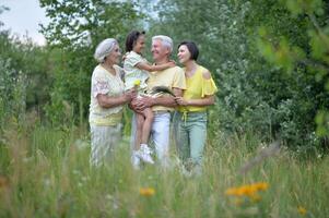 A happy family walks in the park photo