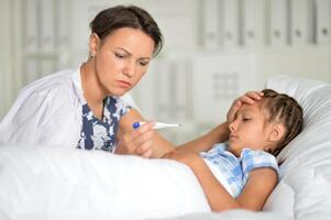 A little girl with her mother in the hospital photo