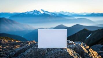 Blank white square on top of mountain with mountains in background photo