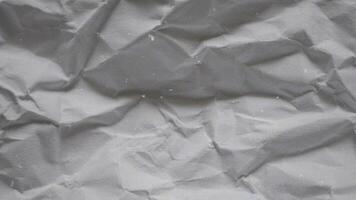 crumpled wrinkled sheet of paper background texture. Stop motion animation. Seamless looping video