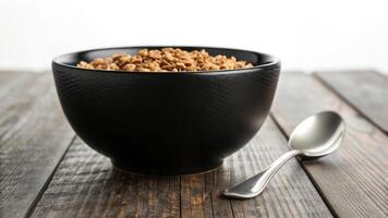 A bowl of granola on a wooden table photo