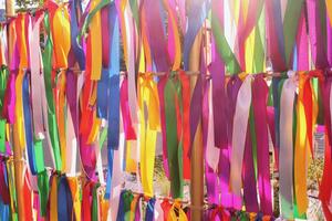 Colorful ribbons hanging vertically, creating a festive and celebratory atmosphere. Variety of colors, textures, and patterns, symbolizing diversity and joy. photo