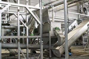 Sustainable brewing steel tanks and pipes in a modern facility for eco-friendly beer production. Industrial brewing equipment and clean brewing technology in a sustainable food processing environment photo