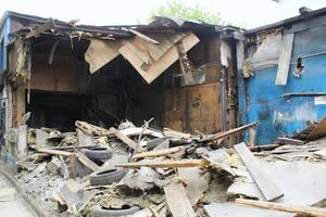 Damaged building interior after fire, with debris, burnt furniture, and broken windows. Devastation and aftermath concept photo