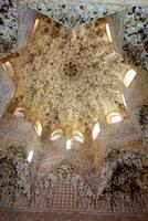Intricate star-shaped ceiling with muqarnas stalactite vaulting in the Sala de los Abencerrajes, Alhambra Palace. Granada, Spain - June 12, 2016 photo