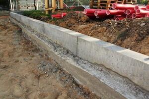 Close-up of sustainable concrete curb. Construction site with environmental responsibility. Eco-friendly Installation recycled project for green infrastructure development. Conscious urban design photo