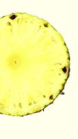Close up of half pineapple rotating seamless loop against white video