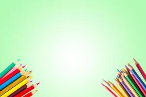Colorful Pencils on Green Background with Copy Space for Creativity and Art Concepts photo