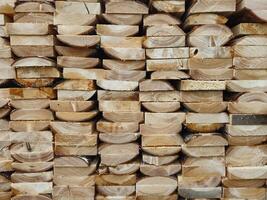 Stacked Wooden Logs Arranged in Neat Horizontal Alignment Close-Up photo